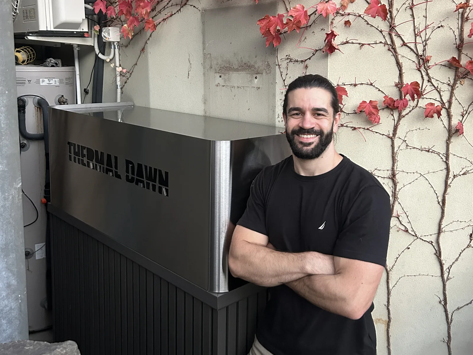 Nick Zeniou, founder, beside the installed Thermal Dawn store and heat pump at the Hawthorn home